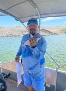 Jaime Flores holding up a fish.