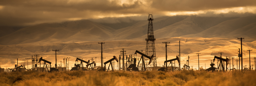 Landscape photograph of the silhouette of an oil and gas operation location